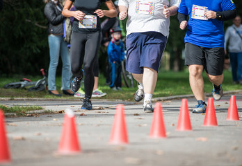 Group of unrecognizable runners outdoors. Long distance running.