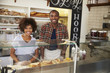 © Monkey Business - Black couple waiting behind the counter at a sandwich bar