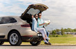 © Syda Productions - happy man and woman with road map at hatchback car