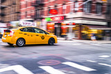 Fototapeta Koty - NYC taxi in motion. Blurred, long exposure images.