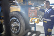 © Westend61 - Repairman tuning tire with machine