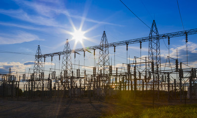 sunset behind substation towers.