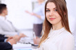 © rogerphoto - Portrait of a young business woman at  meeting.