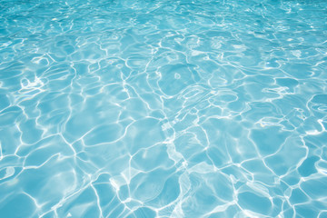  Blue water surface in swimming pool witn sun reflection