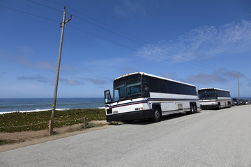 tour buses along pacific ocean