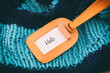 words on paper, knitted blue background, knitted scarf
