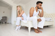 © mast3r - Young Couple Sitting Separate On Bed, Having Conflict Relationships Problem, Sad Negative Emotions Hispanic Man And Woman Lovers Argue In Bedroom