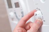 Fototapeta  - Hand Turning Dial on Boiler Unit or Appliance