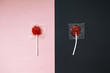 lollipops on pink and black background. the contrast between the whole and broken candy lollipop. the concept of contrast. before and after. top view
