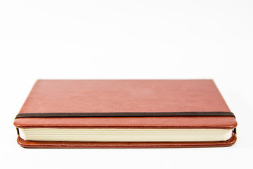 Small brown notebook isolated in white background.