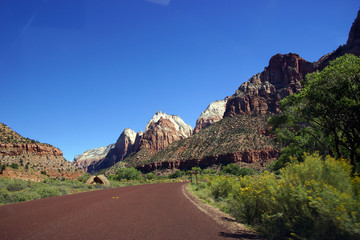 Wall Mural - Highway traffic driving beneath the mountains