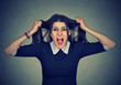 Stress. Woman stressed is going crazy pulling her hair in frustration