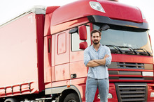 Masculine Truck Driver In Jeans With His Truck Behind