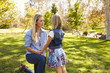 © Monkey Business - Mother and young daughter talking in a park, close up
