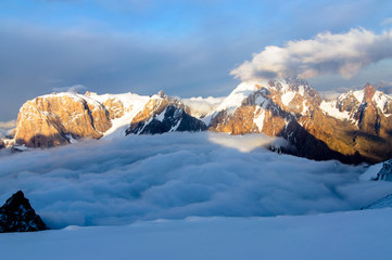 mountains above the clouds lit by the sun