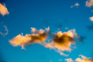 Wall Mural - Puffy and colorful sunset clouds