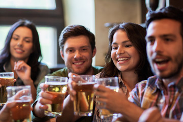 Poster - happy friends drinking beer at bar or pub