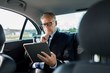 © Syda Productions - senior businessman with tablet pc driving in car
