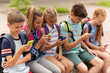 © Syda Productions - elementary school students with smartphones