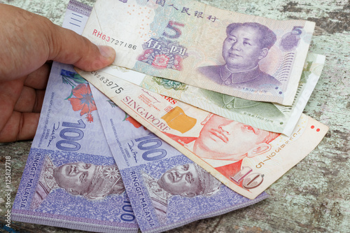 Hand Hold Money In Different Currency Malaysian Ringgit Singapore Dollar And China Renminbi Concept Of Working In Different Country Economy Difference Economy Financial Issue And Migration Stock Photo Adobe Stock