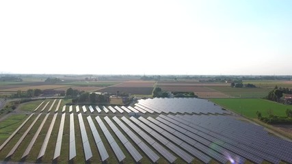 Wall Mural - Power plant using renewable solar energy with sun. Aerial view.