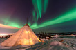 Traditional Sami reindeer-skin tents (lappish yurts) in Troms region of Norway .The polar lights in Norway .