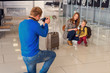 © Yakobchuk Olena - Happy family making photo in airport