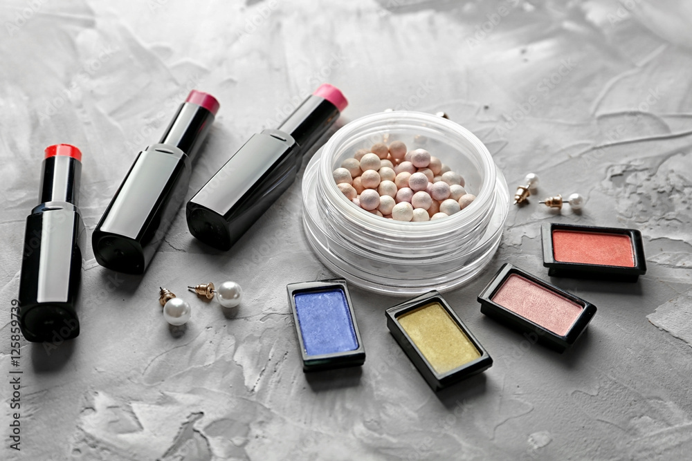 Decorative cosmetic set on grey textured background