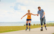 © anetlanda - Young couple on roller skates riding outdoors