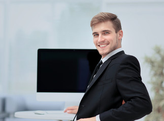 Image of businessman working in office in front  his laptop co