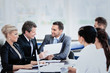 © ASDF - Image of business partners discussing documents and ideas at meeting
