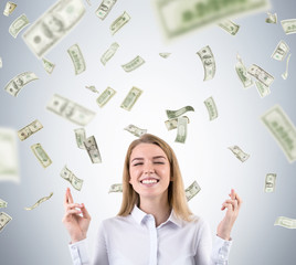 Blond woman is standing against gray background and hoping it wi