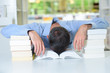 Man with head slumped in a book