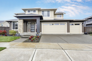 Curb appeal of brand-new home in brown and beige colors