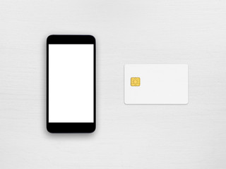 Smartphone and credit card on white table top view