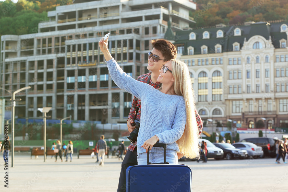 Young couple taking selfie on a street