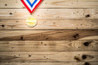 Award of Victory. Winners at the best games, gold medal On the wall of wood