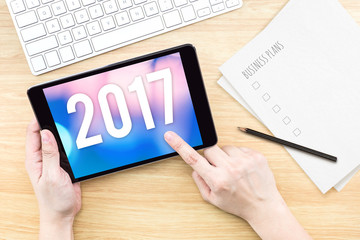 Poster - Hand touch tablet with 2017 year number on screen with business