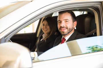 Latin coworkers driving on a business trip