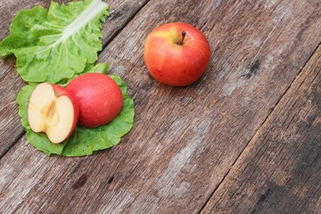 red apple ripe and Vegetable on the table wood 