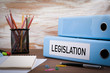 Legislation, Office Binder on Wooden Desk. On the table colored