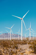Wind turbines on a windfarm in California USA.  Vertical landscape with a wind turbines.