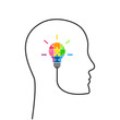 Creative thinking and strategic planning concept. Human head line with light bulb made of colourful puzzle pieces. 