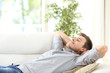 Relaxed man resting on a couch at home