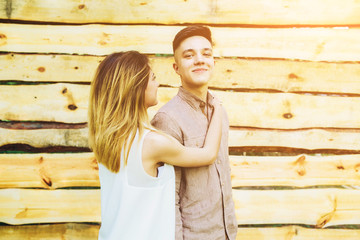 Wall Mural - couple posing on a background of the wooden wall