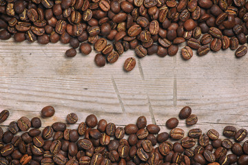 Coffee beans on grunge wooden background