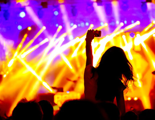 Wall Mural - Fans cheering at open-air live concert. Image not in focus