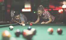 Couple Playing Billiards Together