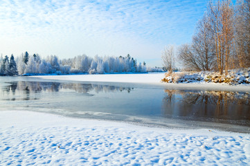 Wall Mural - Winter landscape with frozen river and forest in the frost