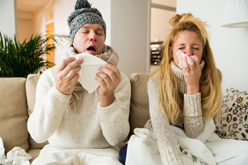 sick couple catch cold. man and woman sneezing, coughing, got flu, having runny nose.